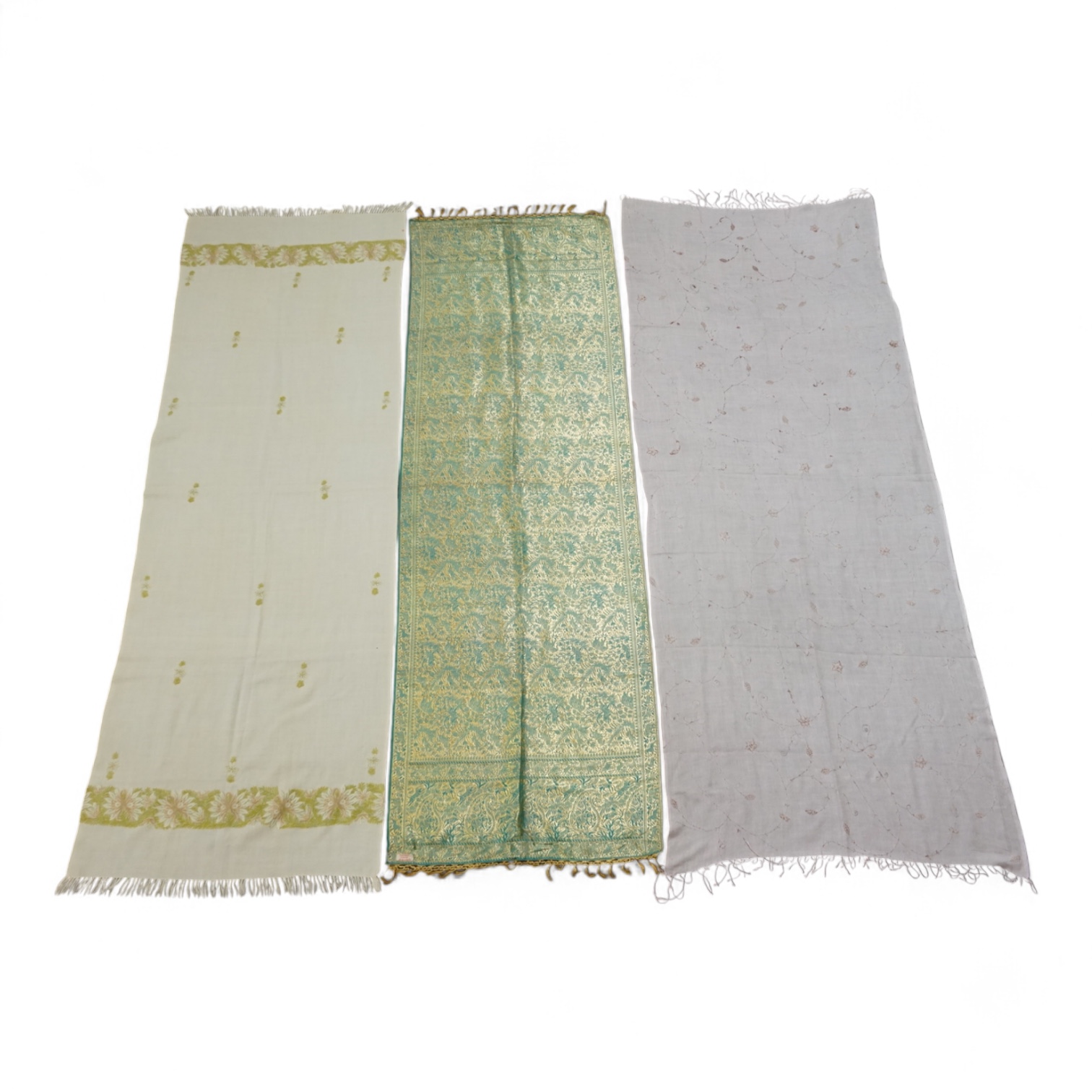 An Indian green and gold silk hand woven brocade stole, a cream pashmina embroidered stole and a similar finely woven and embroidered lilac stole (3). Brocade stole 38cm x 180cm., Condition - light stain to finely woven